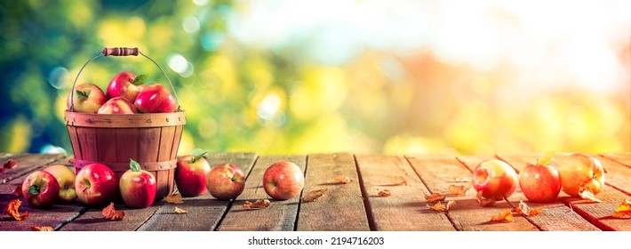 Apples In Wooden Basket On Table At Sunset - Autumn And Harvest Concept - Shutterstock ID 2194716203