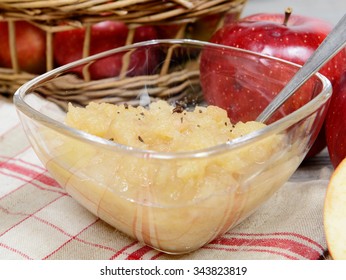 Applesauce With Some Apples In A Glass Cup