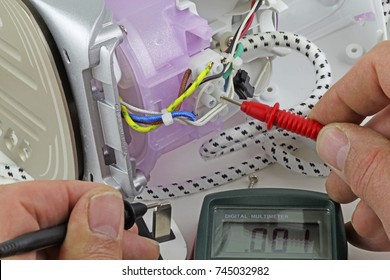  Appliance testing – An electrician fault finding an electric iron .