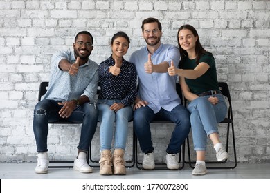 Applicants new employees passed job interview getting position in company showing thumbs up. Corporate staff excellent working conditions, clients great qualified services recommend, positive feedback - Powered by Shutterstock