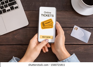 Application for Buying Tickets Online On Smartphone Screen In Female Hands. Closeup