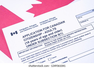 Application For Canadian Citizenship - Adults. Immigration, Refugees And Citizenship Canada Form On Canadian Flag Surface. 