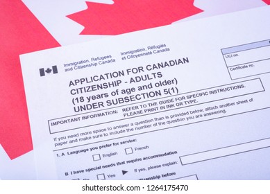 Application For Canadian Citizenship - Adults. Immigration, Refugees And Citizenship Canada Form On Canadian Flag Surface. 