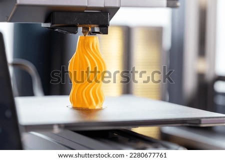 Application for control 3D printer displayed on smartphone. Against the background, a 3D printer prints detail