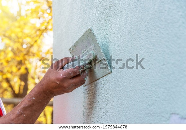 Application Of Facade Plaster,Worker Plastering\
The Facade Of The Building,\
Close-Up.