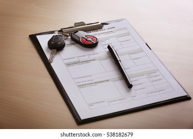 Application Form For Car Loan, Pen And Key On Wooden Table