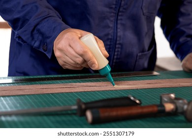 application of glue to the leather, creation of a leather handicraft - Powered by Shutterstock