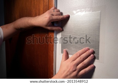Application of metal and mesh patch over damaged drywall hole