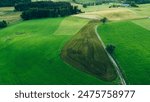 Application of organic fertilizers and humus to green pastures in europe and germany, aerial photo and landscape 