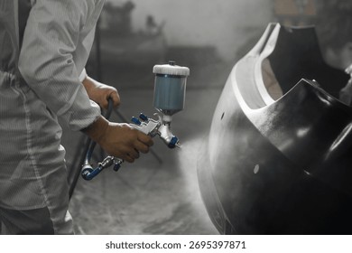Application of primer before the main spray painting of the car bumper. 