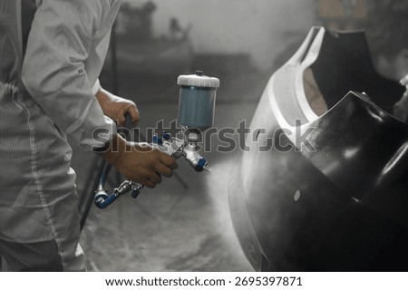 Application of primer before the main spray painting of the car bumper. 