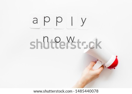 Apply now announcement symbol with megaphone and text on white background top view