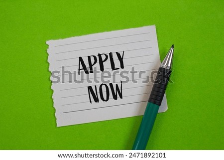 Apply now message written on ripped paper piece with greenbackground. Conceptual apply now symbol. Copy space.