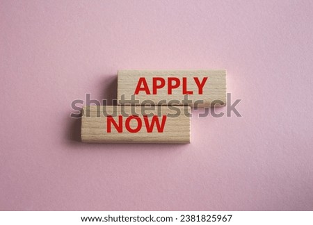 Apply now symbol. Concept word Apply now on wooden blocks. Beautiful pink background. Business and Apply now concept. Copy space