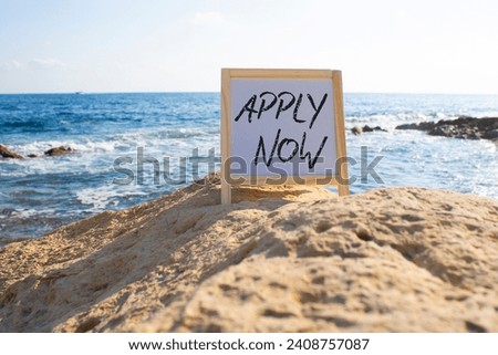 Apply now symbol. Concept word Apply now on white chalk blackboard. Beautiful sea background. Business and Apply now concept. Copy space
