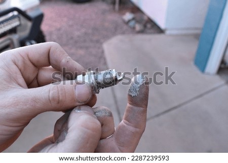 Applying Anti Seize to Spark Plug Threads in Driveway