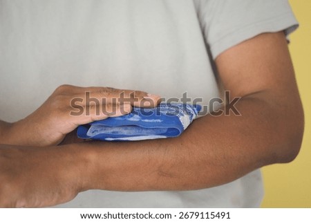 Applying a cold compress to reduce arm swelling at home
