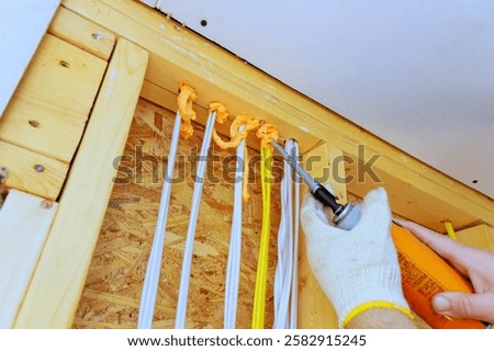 Applying insulation foam to prevent drafts improve energy efficiency in an indoor space during home renovation.