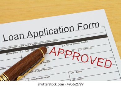 Applying For A Loan Approved, Loan Application Form With A Pen On A Desk With An Approved Stamp