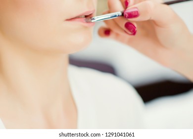 applying make up to brides lips