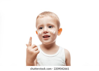 Applying Moisturizing Cream On Baby Face On White Background. Care About Children Clean And Soft Body Skin.