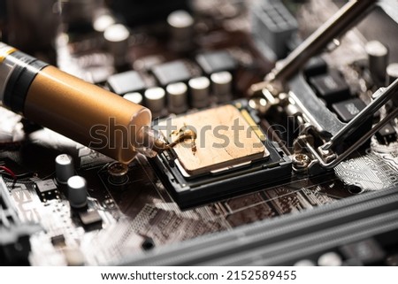Applying new thermal paste to a CPU. Thermal paste used as an interface between heat sinks and CPU.