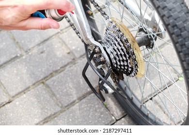 Applying oil on mountain bike chain. Man hands lubing bicycle chain. Technical expertise taking care Bicycle Shop. Lubing bike chain.