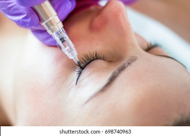 Applying Permanent Eyeliner On Young Girl, Close Up