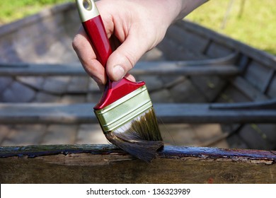 Applying A Pine Tar On A Wooden Boat, To Protect And Preserve The Wood.