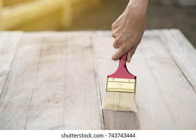 Applying Protective Varnish On A Wooden Texture