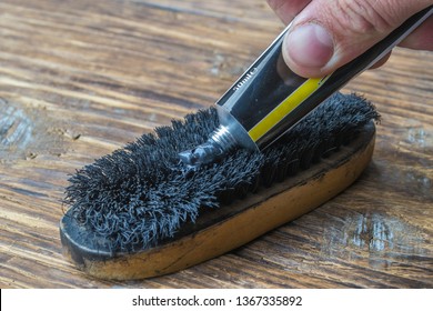 Applying Shoe Polish To A Brush.