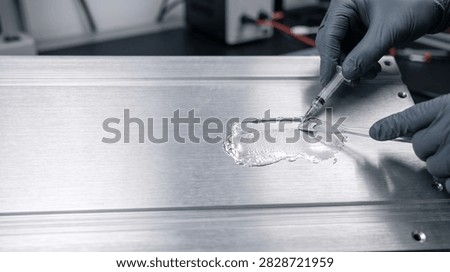 Applying thermal paste to a CPU heatsink for computer hardware cooling and maintenance