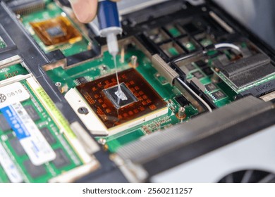 applying thermal paste to a laptop processor for heat dissipation and improved cooling efficiency
