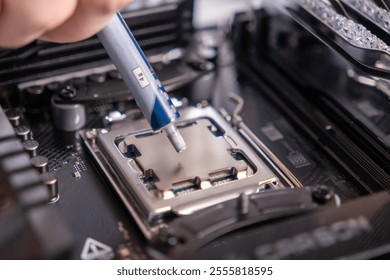 applying thermal paste on processor, CPU installation, computer maintenance, motherboard preparation, technology assembly, close-up, DIY build