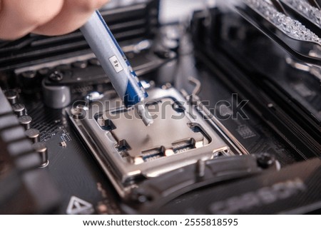 applying thermal paste on processor, CPU installation, computer maintenance, motherboard preparation, technology assembly, close-up, DIY build