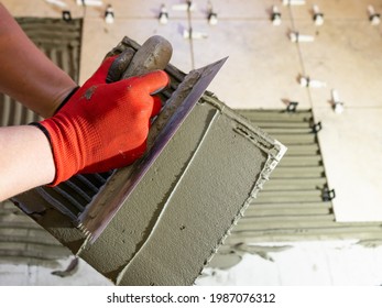 Applying Thinset Mortar On A Tile. Apply The Adhesive, Closeup.