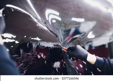 Applying Tinting Foil On Car Window In Garage