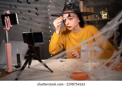 Applying Toner. Asian Girl Cleaning Face With White Pad From Halloween Make Up, Looking At Camera. Beautiful Lady Removing Makeup, Recording Vlog On Phone Camera For Social Media Channel