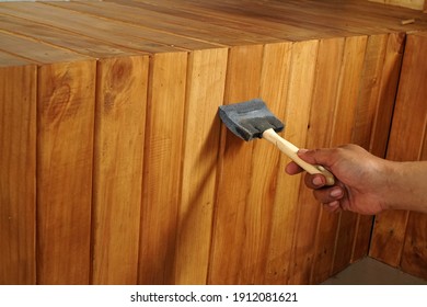 Applying Top Coat Paint With Foam Brush On The Wood Surface 