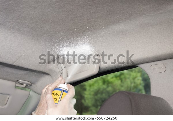 Applying upholstery foam to the headliner of a\
passenger car.
