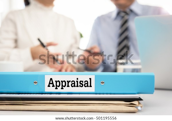 Appraisal documents on desk with manager and\
board are discuss about property appraisal or the appraisal process\
and performance\
ratings.