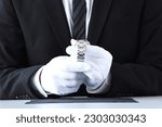 Appraiser checking value and quality of wristwatch