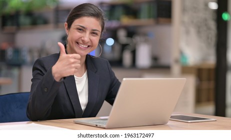 Appreciative Young Indian Businesswoman with Laptop doing Thumbs Up