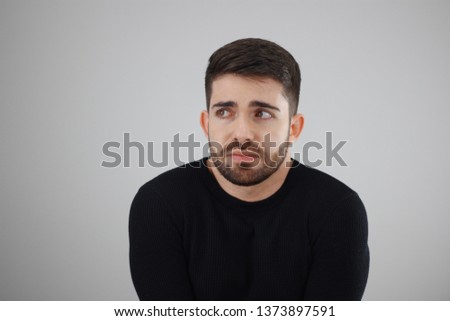apprehensive and distrustful man looking at the fearful, distressed and agonized side - whit space for caption or text
