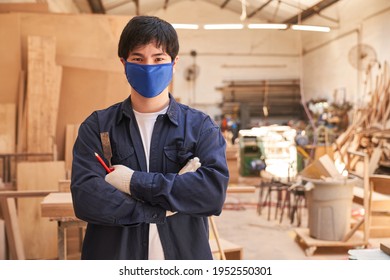 Apprentice Carpenter With Face Mask Because Of Covid-19 In The Carpentry Workshop