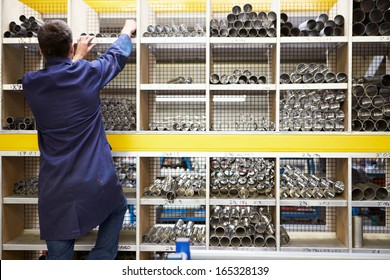 Apprentice Checking Stock Levels In Store Room