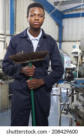 Apprentice In Engineering Factory Sweeping Floor