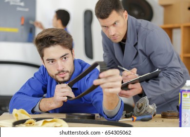 Apprentice Holding A Rubber Belt