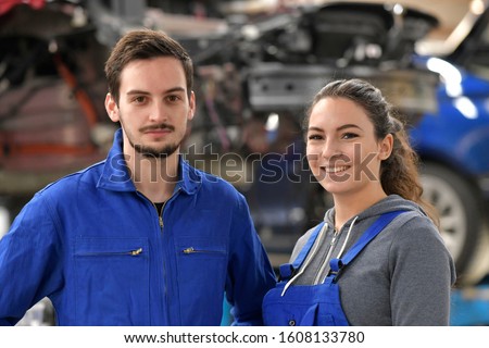 Apprentice working in automobile workshop