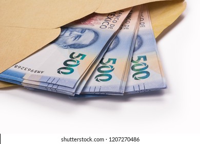 approach to 500 mexican pesos bills inside a yellow envelope, on white background